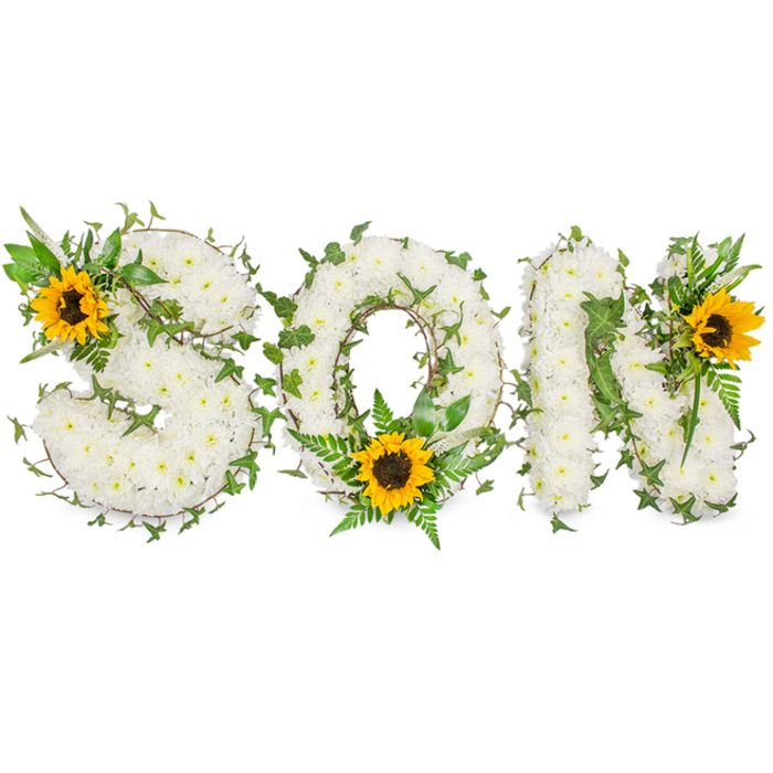 An elegantly composed memorial piece spells out 'SON' in bold, three-dimensional capital letters, each letter densely covered in small, pristine white chrysanthemums to form a tactile, cloud-like surface. The chrysanthemums' compact heads are arranged so the letters read clearly from a short distance while revealing a textured, petal-rich surface up close. Dark green ivy is artfully threaded through and wrapped around each letter, its sinuous stems and glossy leaves creating botanical lines that both define and soften the typography. Additional greenery - feathery fern fronds and sharper-pointed leaves - is layered into the base to provide contrast, dimensionality and a natural silhouette. Three sunflowers, chosen for their broad golden petals and deep brown centres, serve as warm focal points: one is placed on the upper-left curve of the 'S', the second rests low within the 'O' among the ferns, and the third crowns the upper-right of the 'N'. The sunflowers' warm hues balance the arrangement's white-and-green palette, suggesting moments of brightness and treasured memories. The photograph is taken against a stark white backdrop with even, soft lighting to preserve fine detail - every chrysanthemum head, ivy vein and sunflower disk shows clearly without distracting shadows. As a florist familiar with the quiet lanes and village feel of North Ockendon and the surrounding Hornchurch and Cranham areas, I see this tribute as an intimately personalised memorial suited to a family service or graveside farewell - crafted with botanical skill, dignity and a gentle sense of hope.