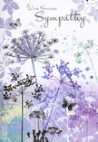 This sympathy card presents a tender, nature-inspired scene that feels very much at home in North Ockendon's calm, open surroundings. Against a softly washed background of muted violet, lavender and silvery green, a cluster of slender wildflower stems rises gracefully from the lower edge of the card. Each stem terminates in a delicate, umbrella-like head of tiny blooms, their forms drawn so lightly they appear almost transparent at the tips, like dried seed heads silhouetted against an evening sky. The watercolour technique creates gentle transitions of colour, with no hard lines-just overlapping veils of soft purple, blue-grey and pale green, reminiscent of the diffused light drifting over nearby fields and lanes. Scattered among the floral silhouettes are a few butterflies, painted with translucent wings that barely catch the eye at first glance. They hover between the stems, suggesting a quiet sense of hope and continued presence rather than bright distraction. The entire composition feels airy and balanced, with ample white space that gives the scene room to breathe. It carries the same quiet dignity we aim for in funeral flowers hand-prepared for local services, where subtlety often speaks more powerfully than bold colour. The cool, calming palette and gentle upward movement of the stems offer a sense of solace and remembrance, making this card a thoughtful accompaniment to condolence flowers delivered to a home, chapel, or service in North Ockendon and the surrounding area.